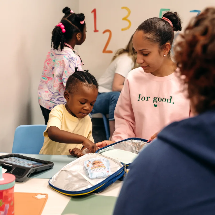 Child participates in an ABA therapy session with a Registered Behavior Technician (RBT) during a structured learning activity in a clinic setting.