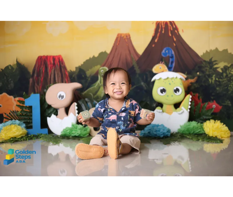 One-year-old boy with autism sitting and playing with toys during an early developmental assessment, highlighting the importance of early diagnosis and intervention.